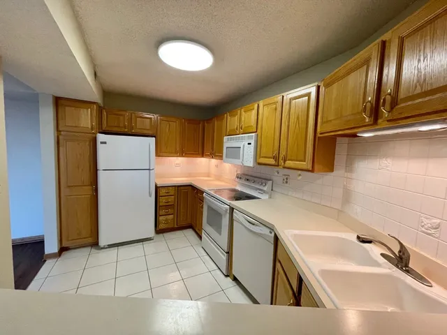 a kitchen with a sink a refrigerator and a sink
