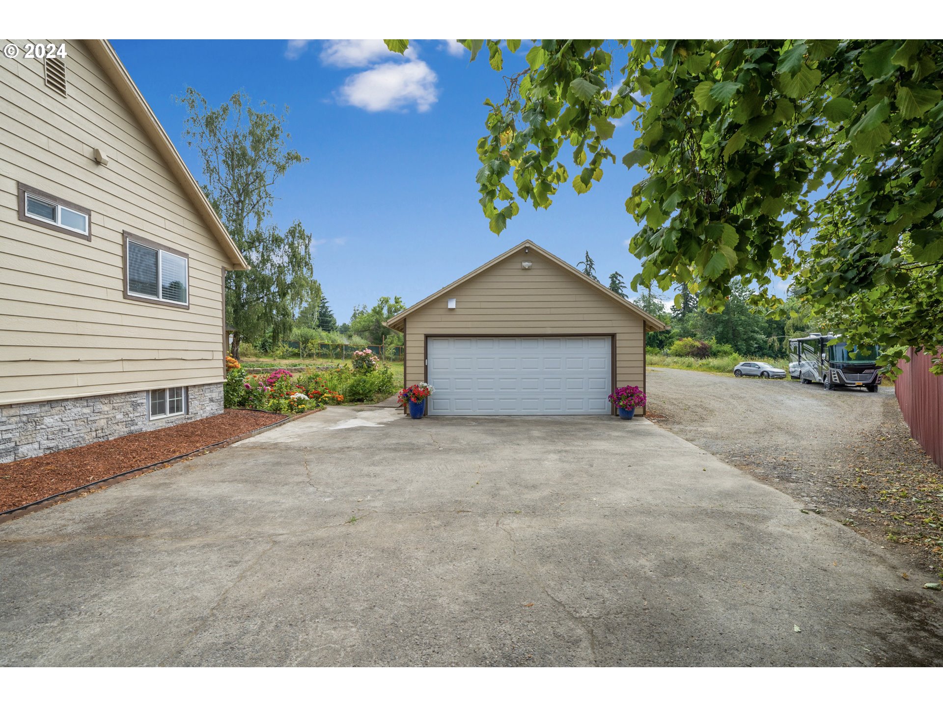 16985 Southeast Foster Road Gresham, OR 97080 - Photo 8 of 48 a front view of a house with a yard and garage