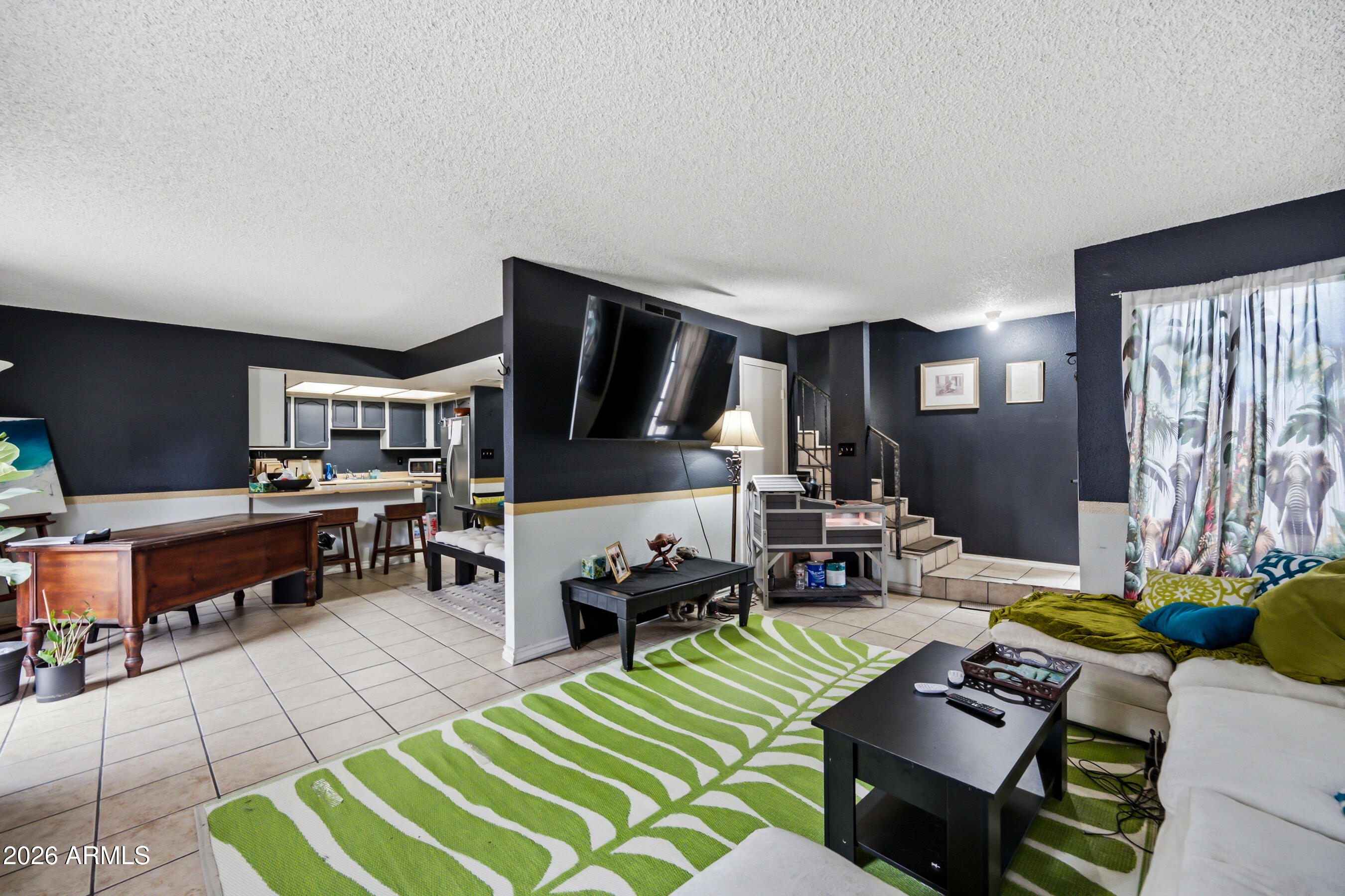 1051 South Dobson Road, Unit 187 Mesa, AZ 85202 - Photo 8 of 18 a living room with furniture and a flat screen tv