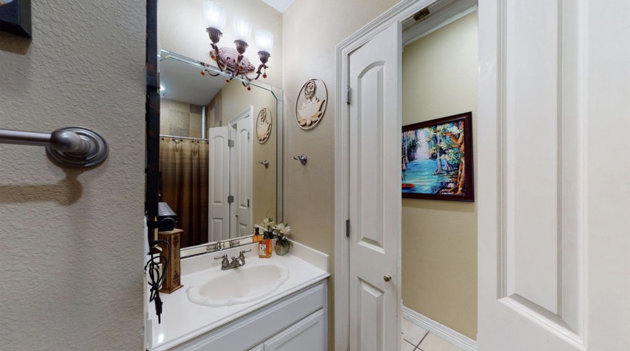 104 Mockingbird Lane Bridge City, TX 77611 - Photo 26 of 27 a bathroom with a sink vanity and a mirror