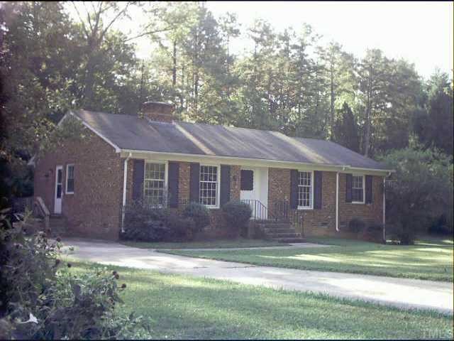 405 Sharon Road Chapel Hill, NC 27517 - Photo 1 of 1 a front view of a house with a garden