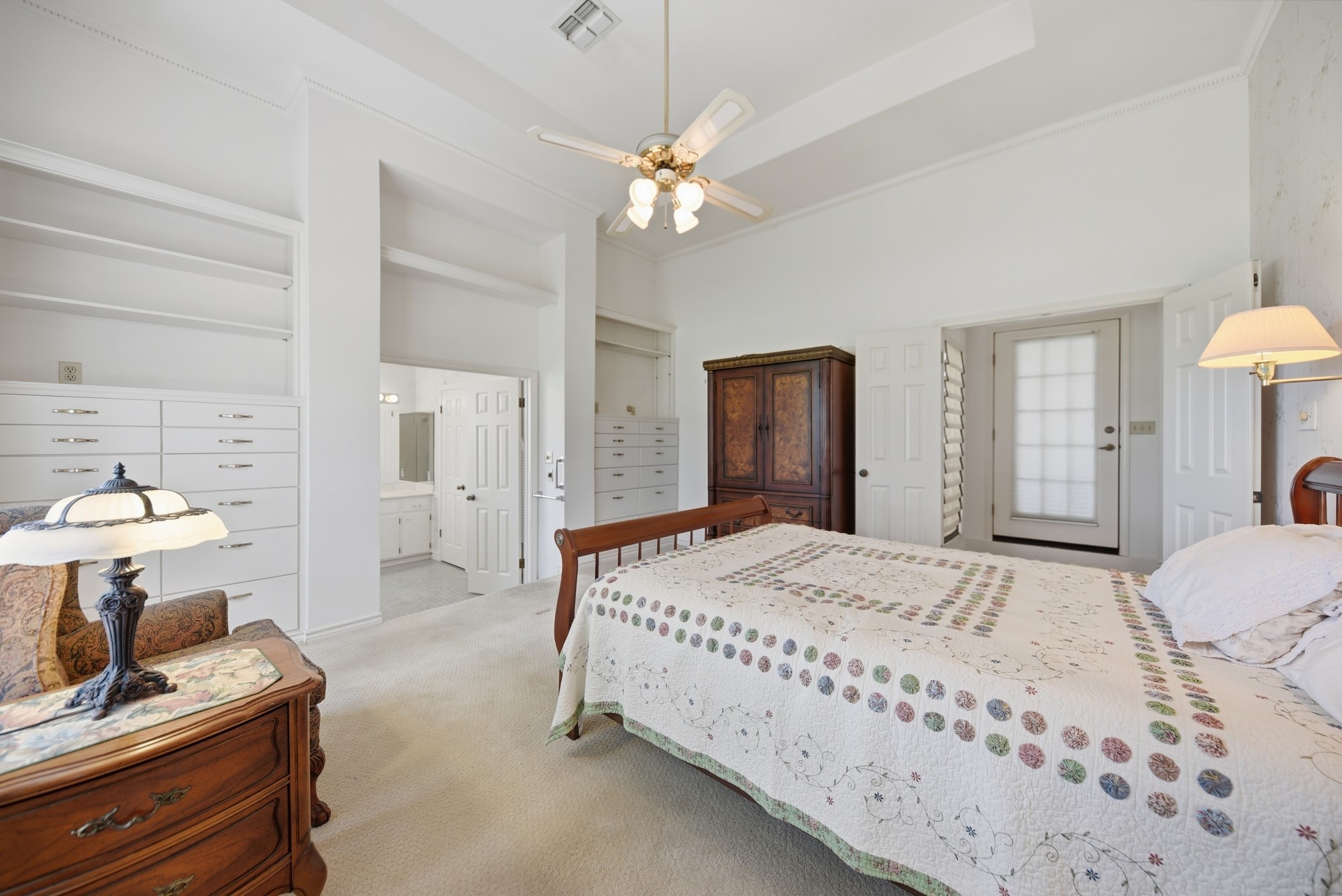 1552 Holub Road Schulenburg, TX 78956 - Photo 19 of 35 A well-lit bedroom suite features built-in storage and access to a private bathroom and an exterior door.
