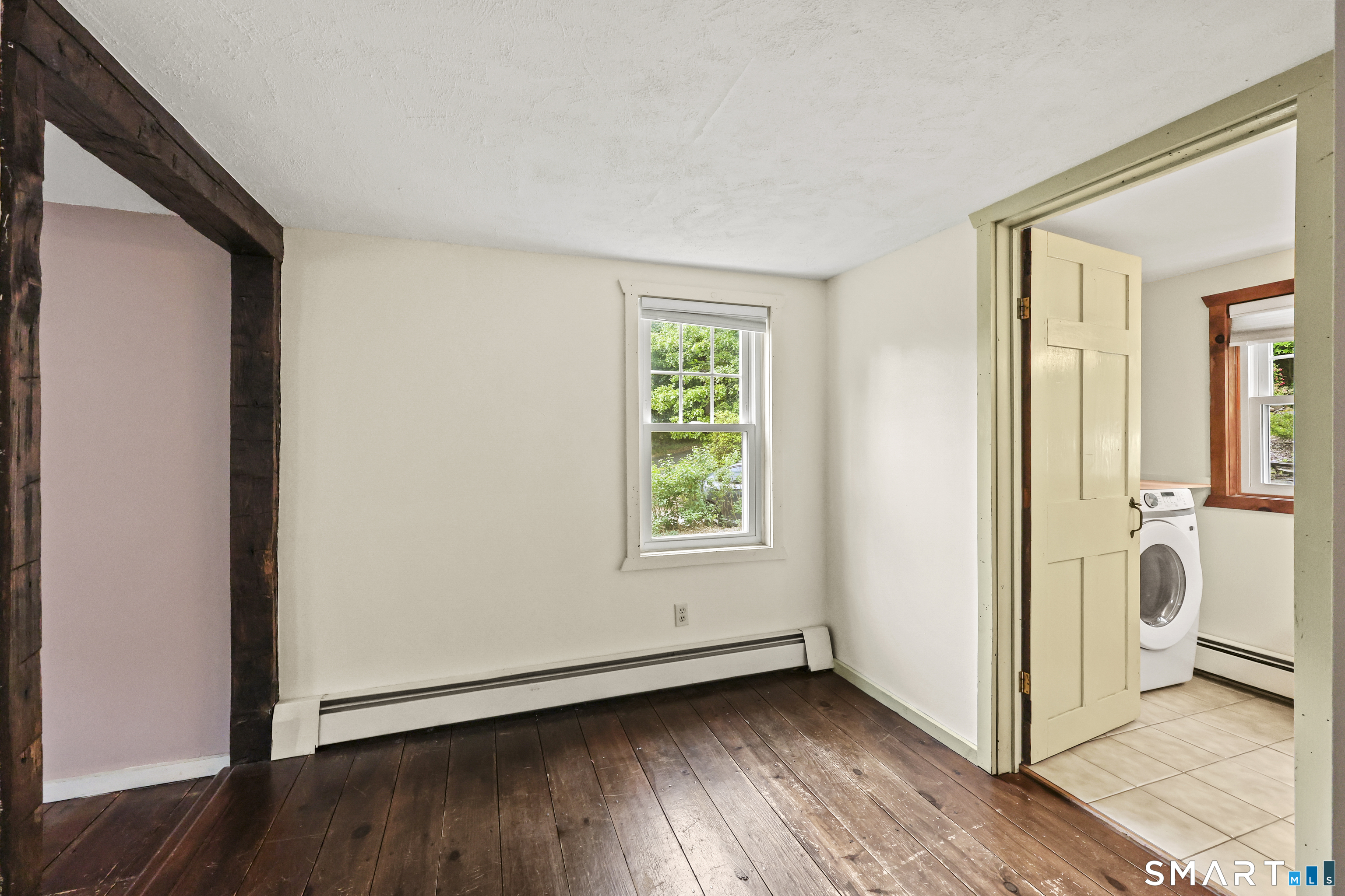 917 Hopewell Road Glastonbury, CT 06033 - Photo 9 of 39 a view of an empty room with wooden floor and a window
