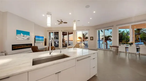 a kitchen with stainless steel appliances granite countertop a sink and a large window