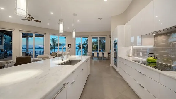 a large white kitchen with lots of counter space and window