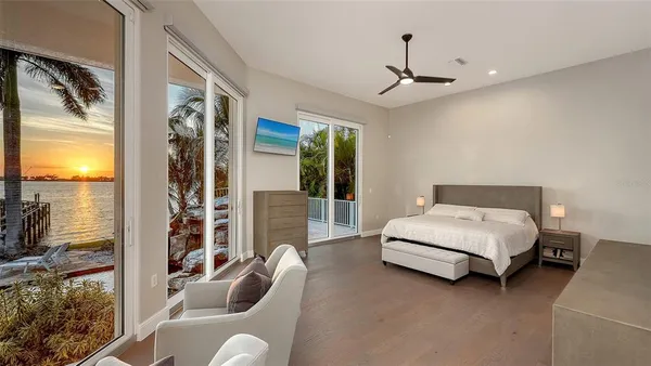 a bedroom with a bed couch and window