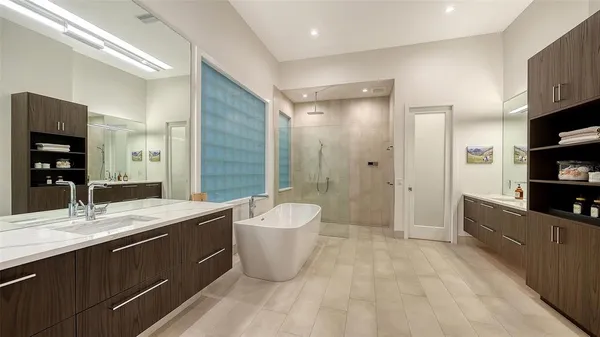 a spacious bathroom with a granite countertop sink a toilet a mirror and shower