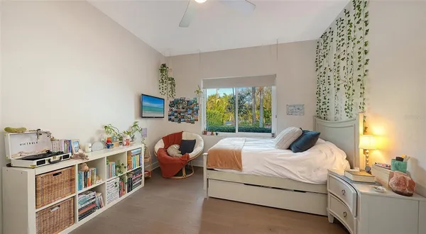 a bedroom with a bed and a window