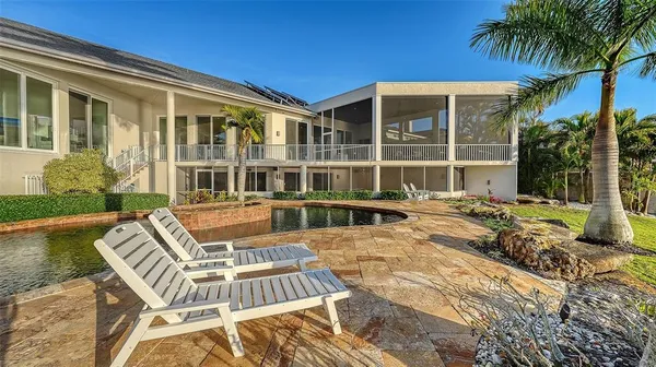 a view of a house with pool and sitting area