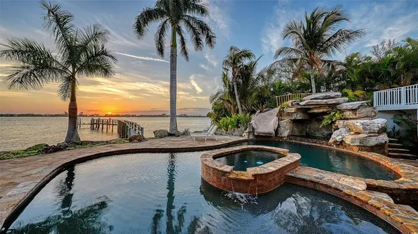 a swimming pool with outdoor seating and plants