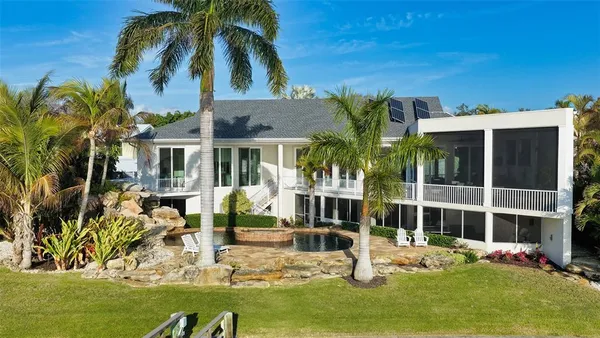 a view of house with yard outdoor seating and swimming pool