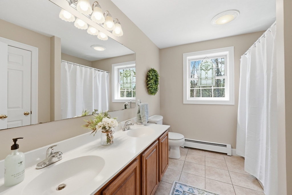 331 East County Road Rutland, MA 01543 - Photo 23 of 37 a bathroom with a sink double vanity and a mirror