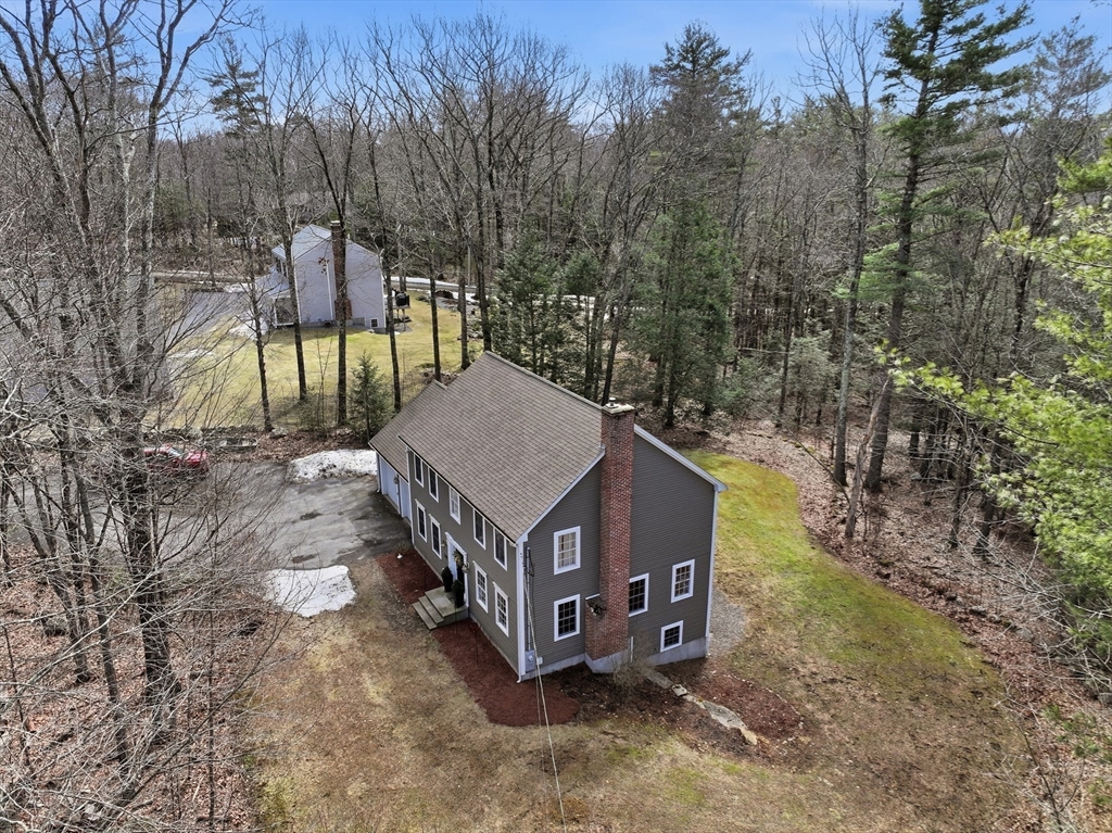 331 East County Road Rutland, MA 01543 - Photo 33 of 37 a wooden bench sitting in the middle of a forest