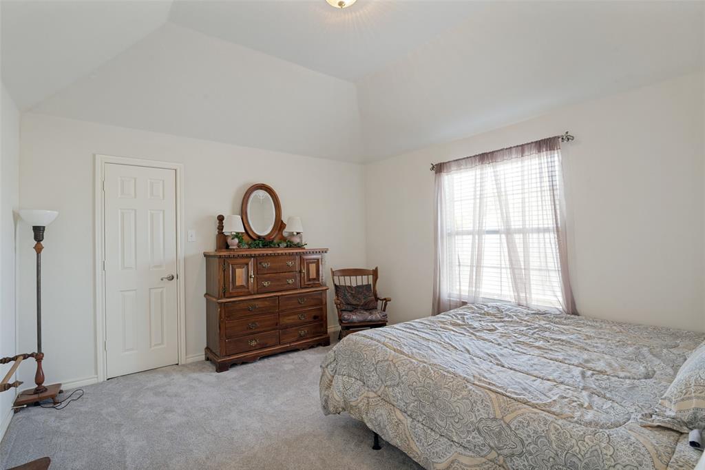 2213 Ranch Road Sachse, TX 75048 - Photo 24 of 28 Vaulted ceiling, white painted walls, natural light from window, white paneled door, light-colored carpeting