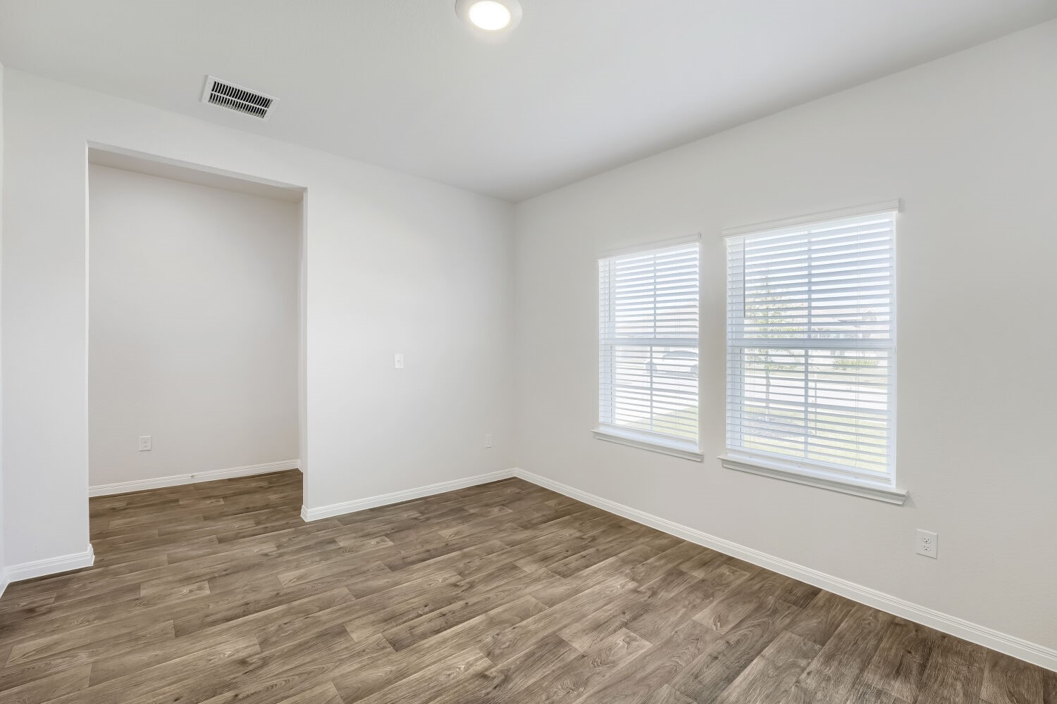 13507 Howser Trace Manor, TX 78653 - Photo 3 of 28 Natural light pours into this bright, airy room with modern wood-look flooring.