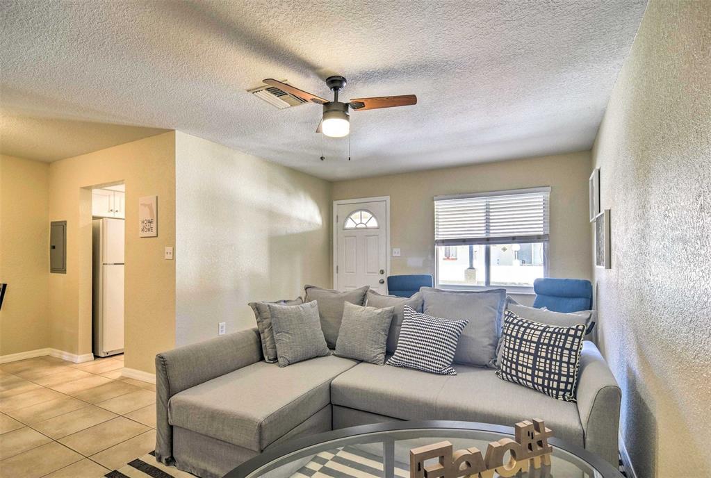 2704 2nd Street, Unit 14 Indian Rocks Beach, FL 33785 - Photo 5 of 21 a living room with furniture and a large window