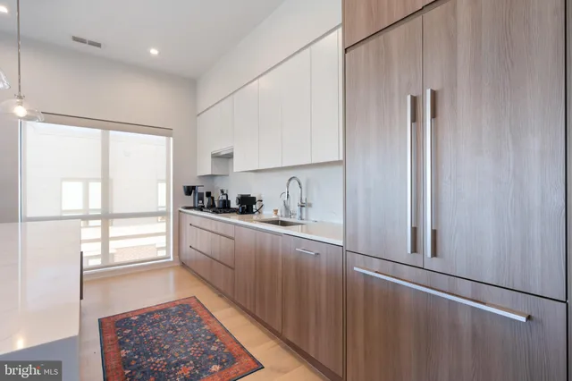 a kitchen with stainless steel appliances granite countertop a refrigerator and a sink