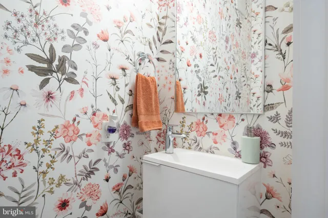 a bathroom with a sink and mirror with toilet