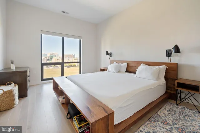 a bed sitting in a bedroom next to a window