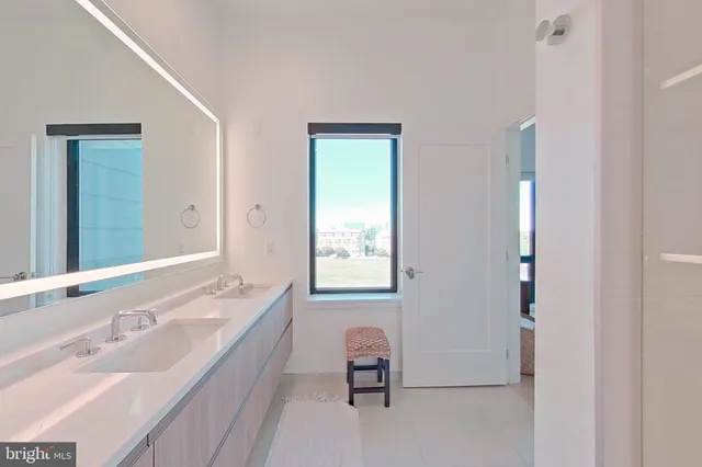 a bathroom with a tub double vanity sink and mirror
