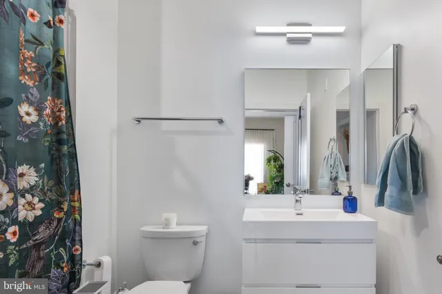 a bathroom with a sink a toilet and mirror