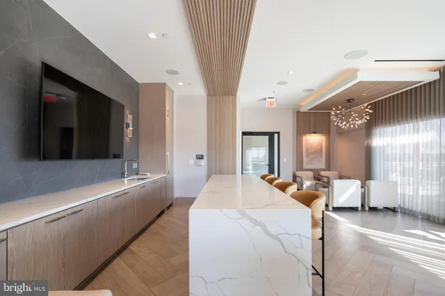 a large bedroom with a large bed and a chandelier