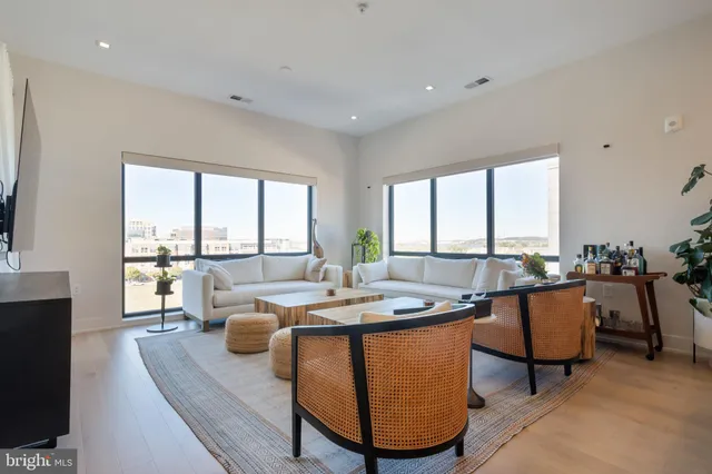 a dining room with furniture a large window and a rug