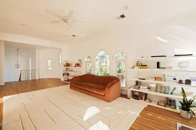a bedroom with furniture and a large window