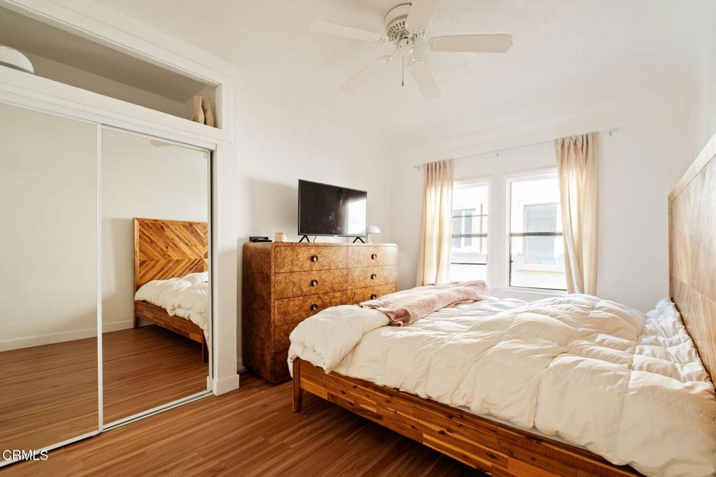 5166 Packard Street Los Angeles, CA 90019 - Photo 13 of 31 a bedroom with a bed and wooden floor