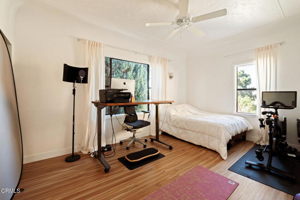 5166 Packard Street Los Angeles, CA 90019 - Photo 16 of 31 a bedroom with a bed and wooden floor