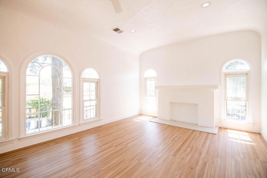 5166 Packard Street Los Angeles, CA 90019 - Photo 20 of 31 an empty room with wooden floor and windows