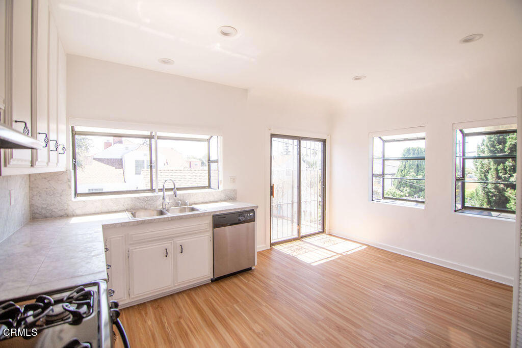 5166 Packard Street Los Angeles, CA 90019 - Photo 22 of 31 a large kitchen with a wooden floor and large window