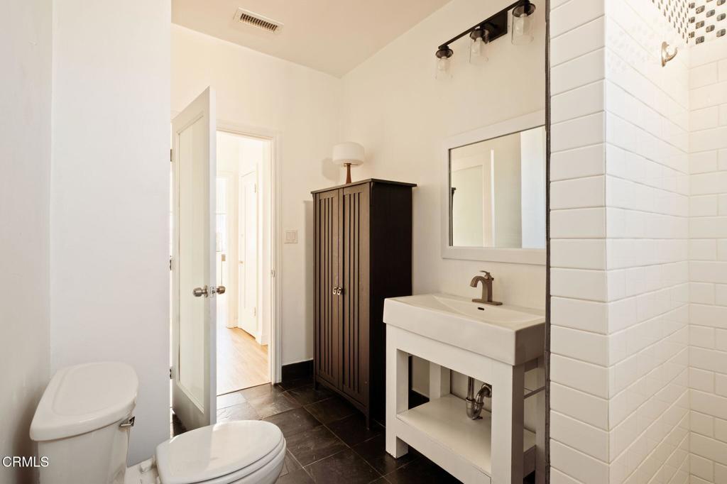 5166 Packard Street Los Angeles, CA 90019 - Photo 27 of 31 a bathroom with a sink a toilet and shower