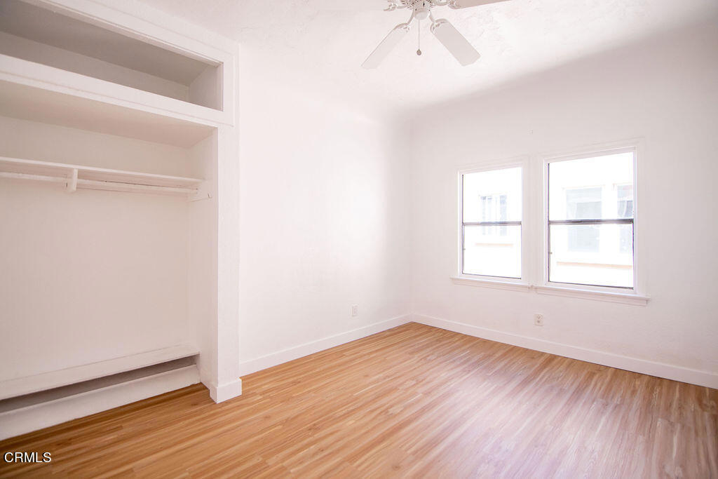 5166 Packard Street Los Angeles, CA 90019 - Photo 28 of 31 an empty room with wooden floor and windows