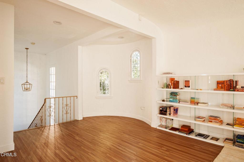 5166 Packard Street Los Angeles, CA 90019 - Photo 5 of 31 a bedroom with a bed and a book shelf