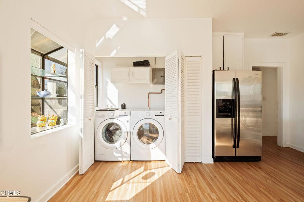 5166 Packard Street Los Angeles, CA 90019 - Photo 6 of 31 a utility room with wooden floor and windows