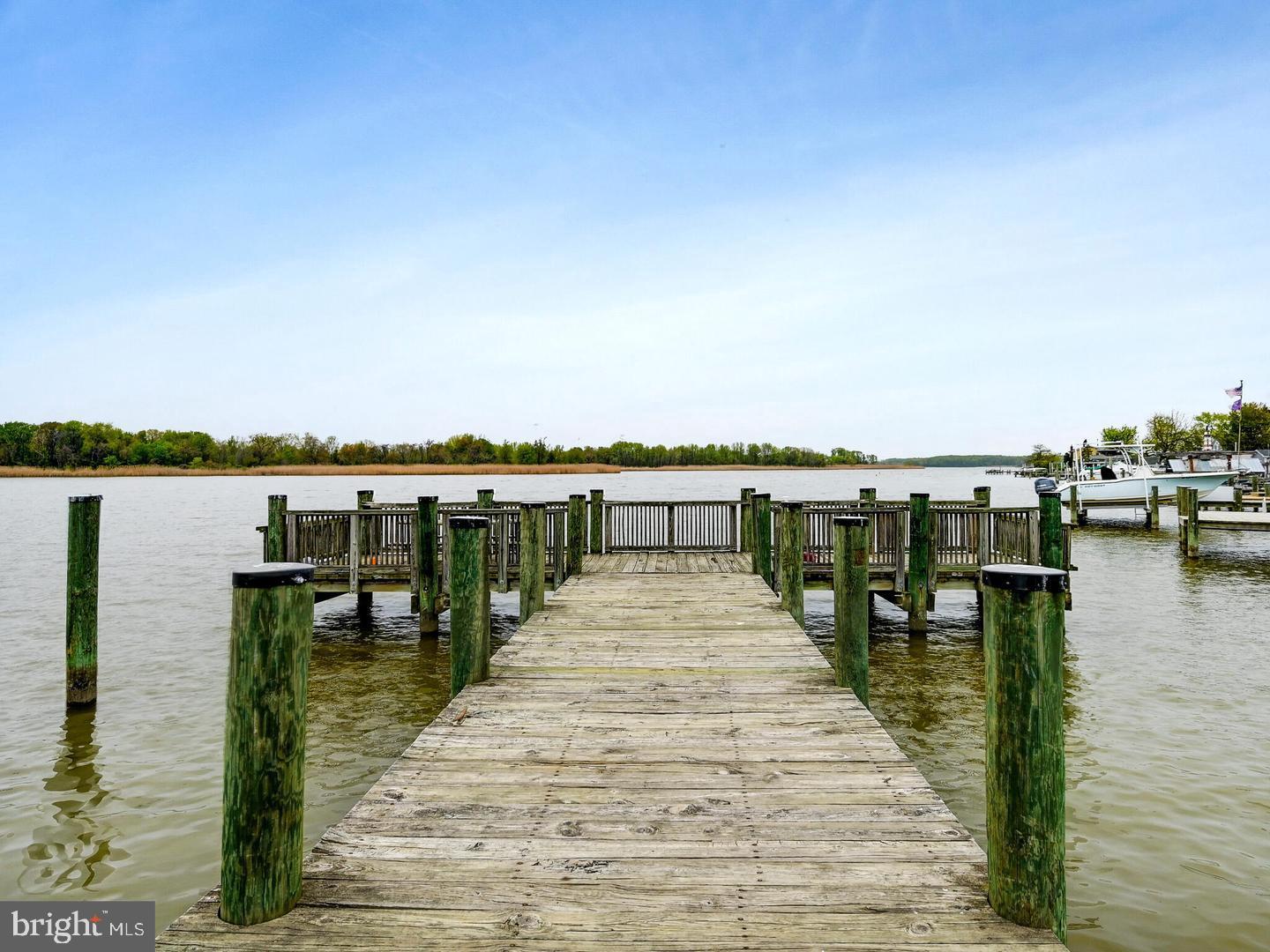 3206 Lynch Road Baltimore, MD 21219 - Photo 52 of 70 a wooden pier with boats and trees in the background