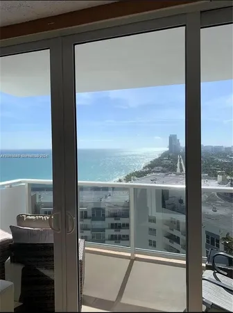 a view of a balcony with a floor to ceiling window