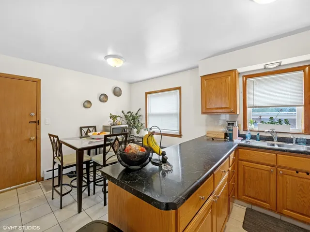 a kitchen with stainless steel appliances granite countertop a sink and a stove