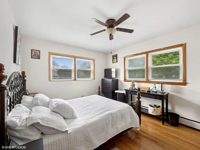 a bedroom with a bed and a large window