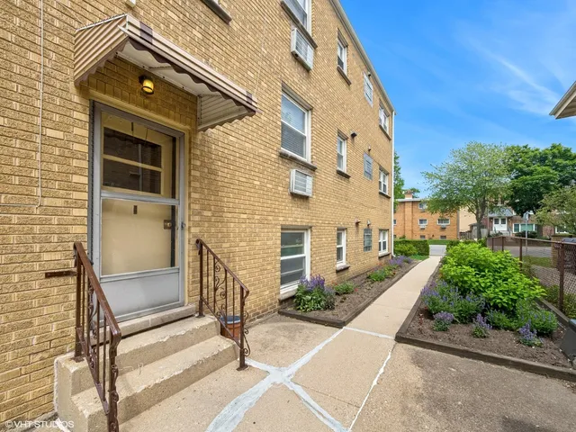 a view of a brick house with many windows