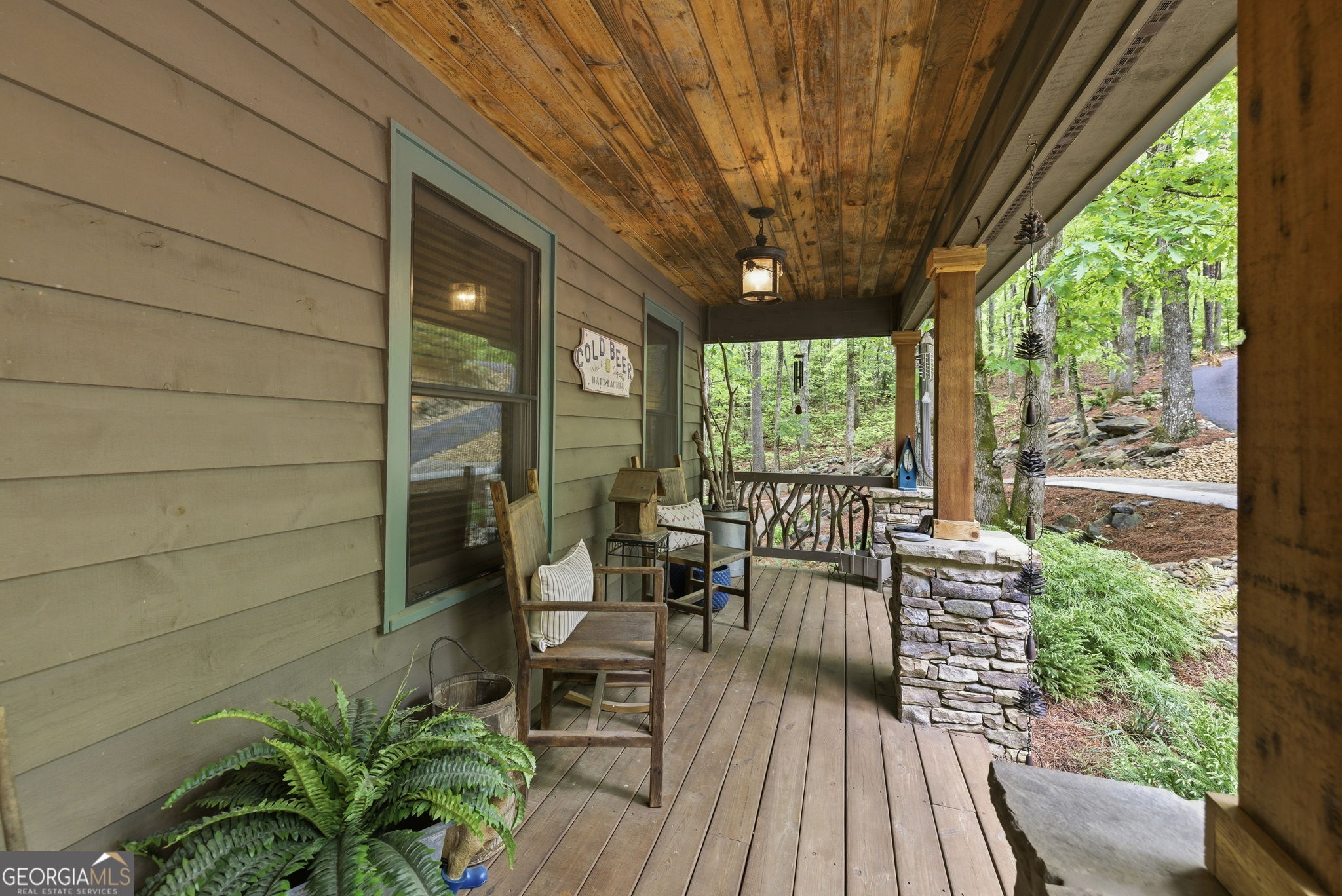 634 Little Hawk Road Sautee Nacoochee, GA 30571 - Photo 4 of 54 a view of a patio with table and chairs potted plants with wooden floor and floor to ceiling window