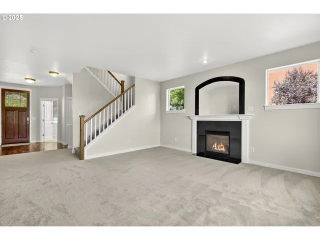 a view of an empty room with a fireplace
