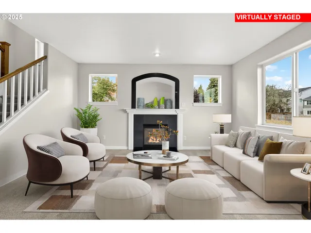 a living room with furniture a fireplace and a large window