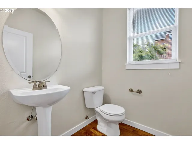 a bathroom with a toilet a sink and mirror