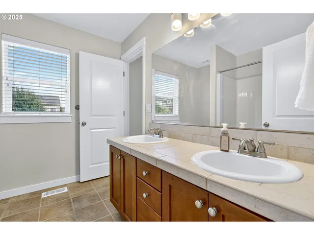 a bathroom with a sink double vanity and a mirror