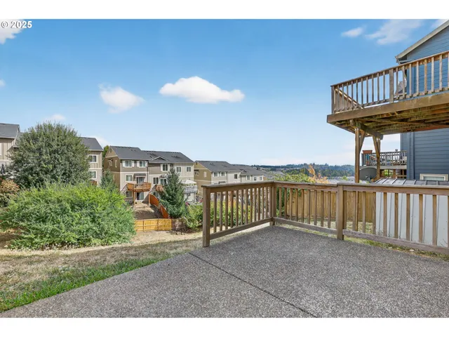 a view of a porch with a floor to ceiling window and wooden fence