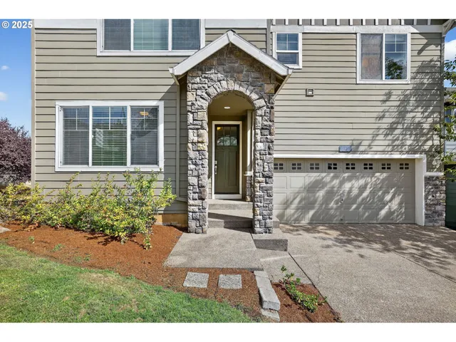 a front view of a house with garden