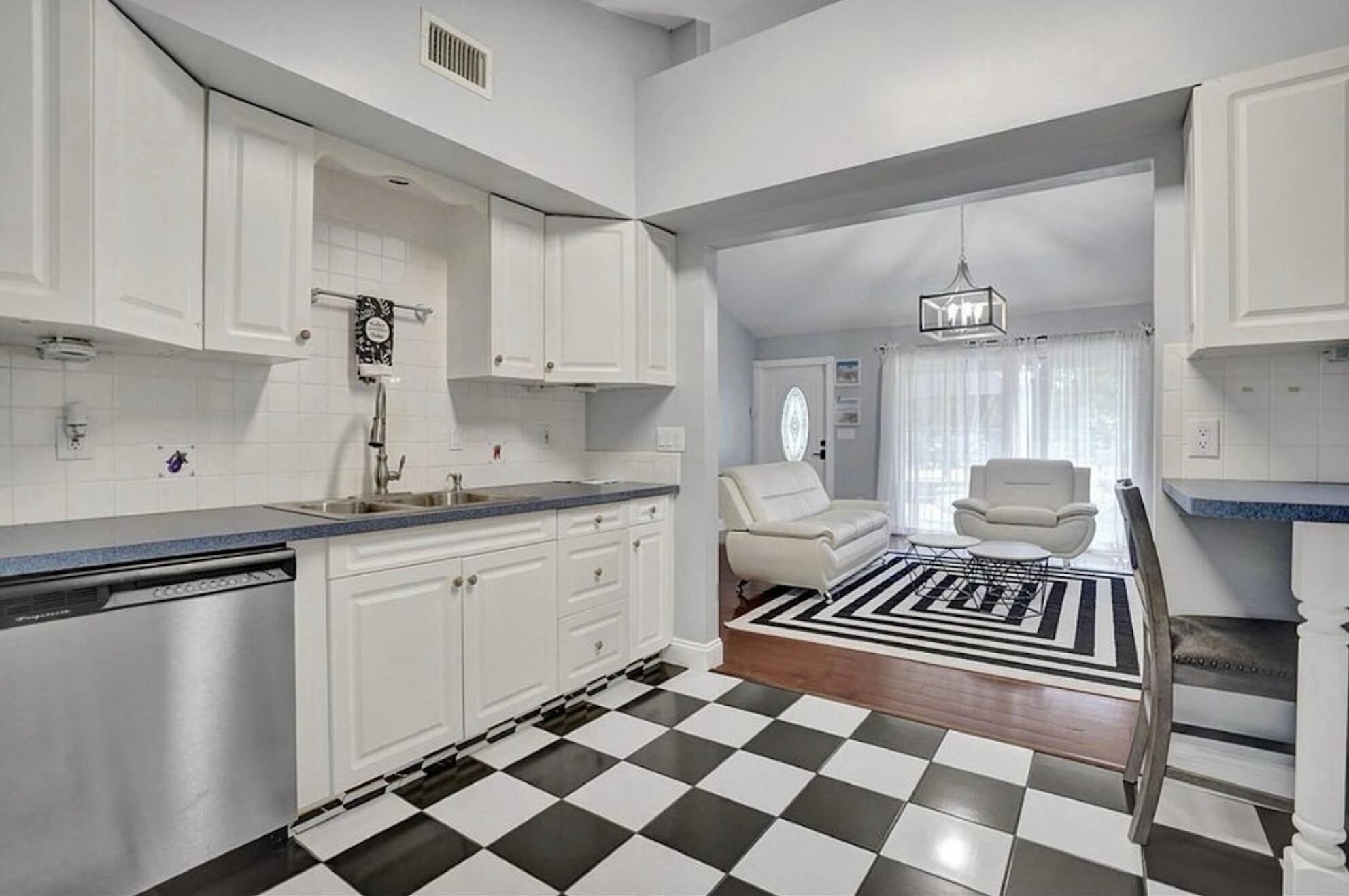 502 Rambling Dr Circle, Unit #2 Wellington, FL 33414 - Photo 11 of 18 a kitchen with a checkered floor and white appliances