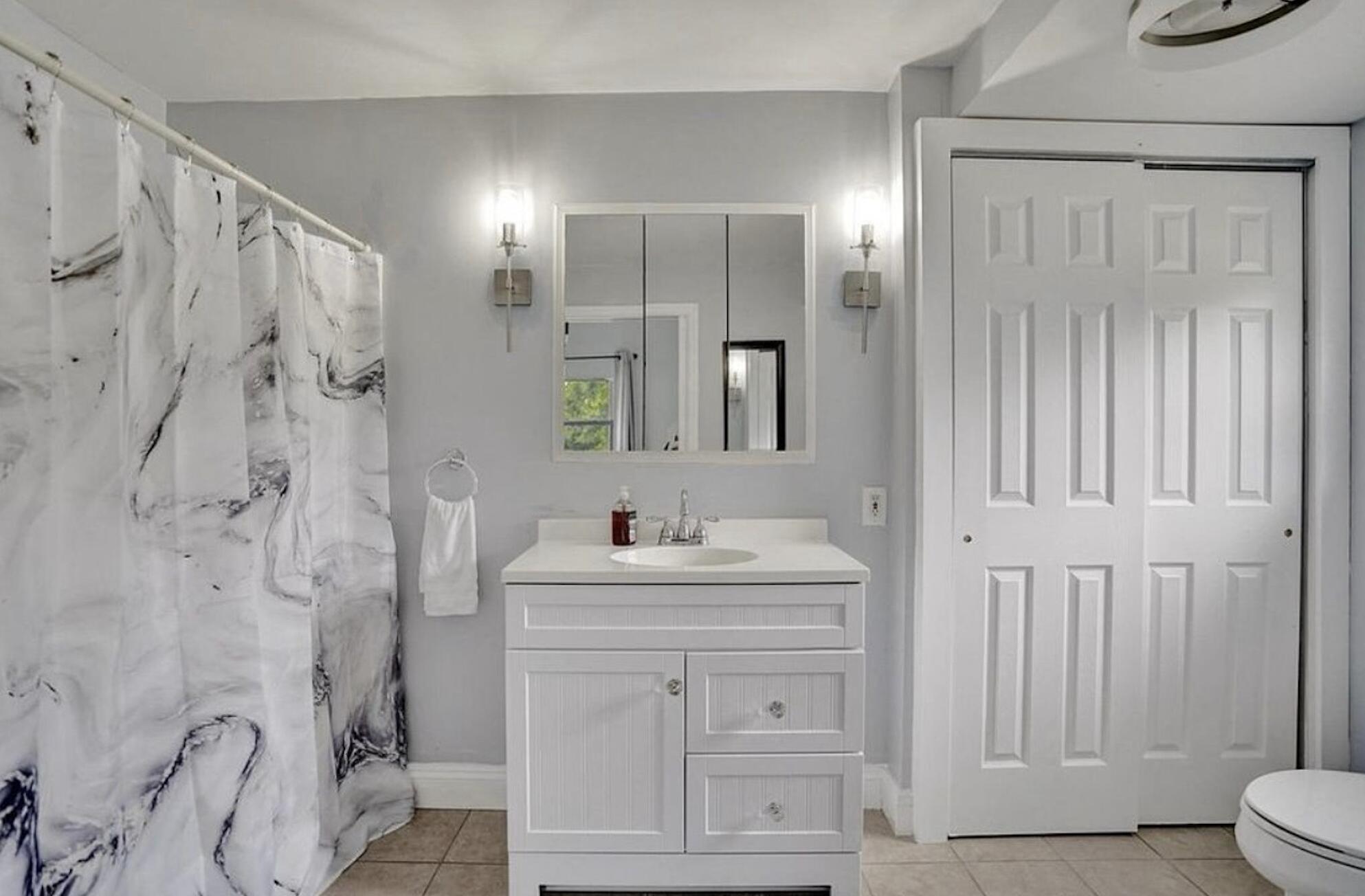 502 Rambling Dr Circle, Unit #2 Wellington, FL 33414 - Photo 14 of 18 a bathroom with a sink a toilet and shower